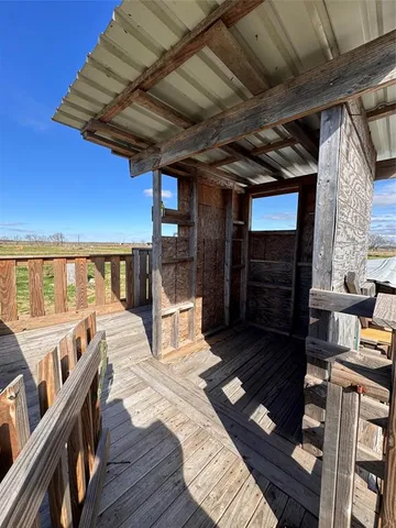 a view of balcony with wooden floor and outdoor seating