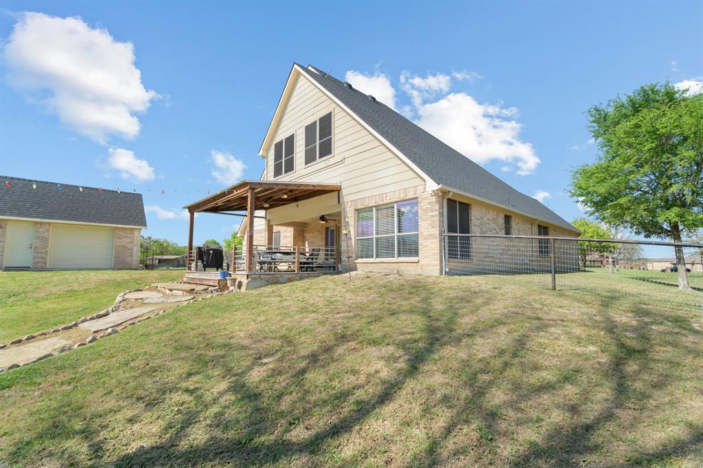 112 Waterfall Court Azle, TX 76020 - Photo 30 of 40 a view of a house with a yard and a garage