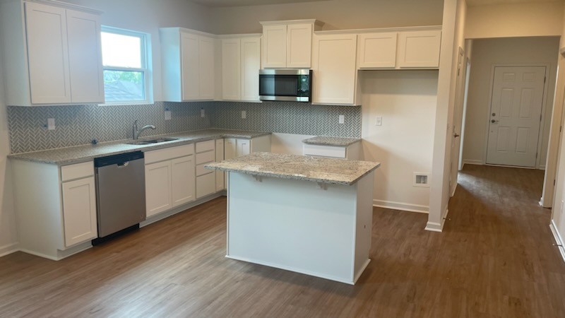3244 Hearth Hollow Road Columbia, TN 38401 - Photo 3 of 32 a kitchen with granite countertop a sink and a stove top oven