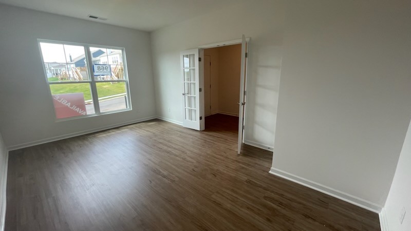 3244 Hearth Hollow Road Columbia, TN 38401 - Photo 6 of 32 an empty room with wooden floor and windows