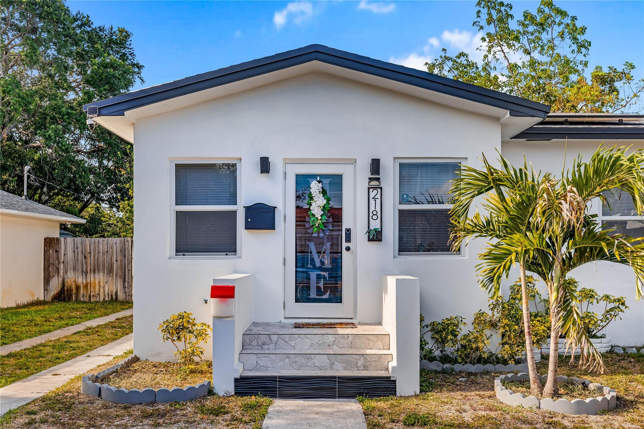 218 Southwest 7th Street Dania Beach, FL 33004 - Photo 2 of 57 a front view of a house with garden