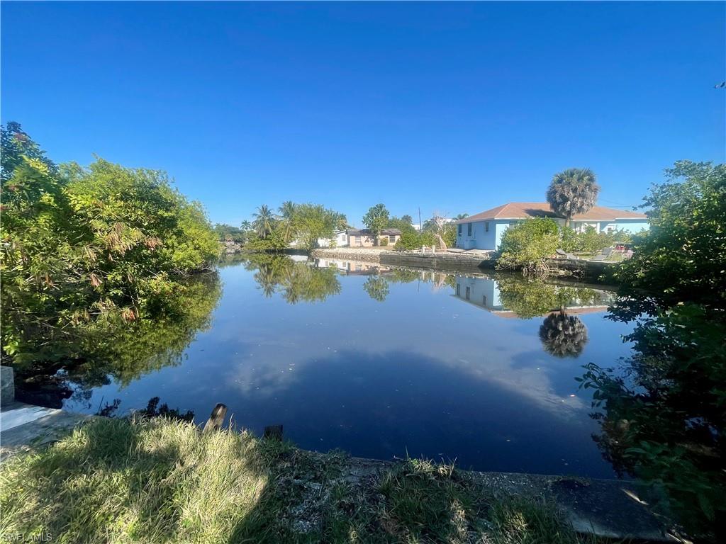 a view of a lake with houses in the back