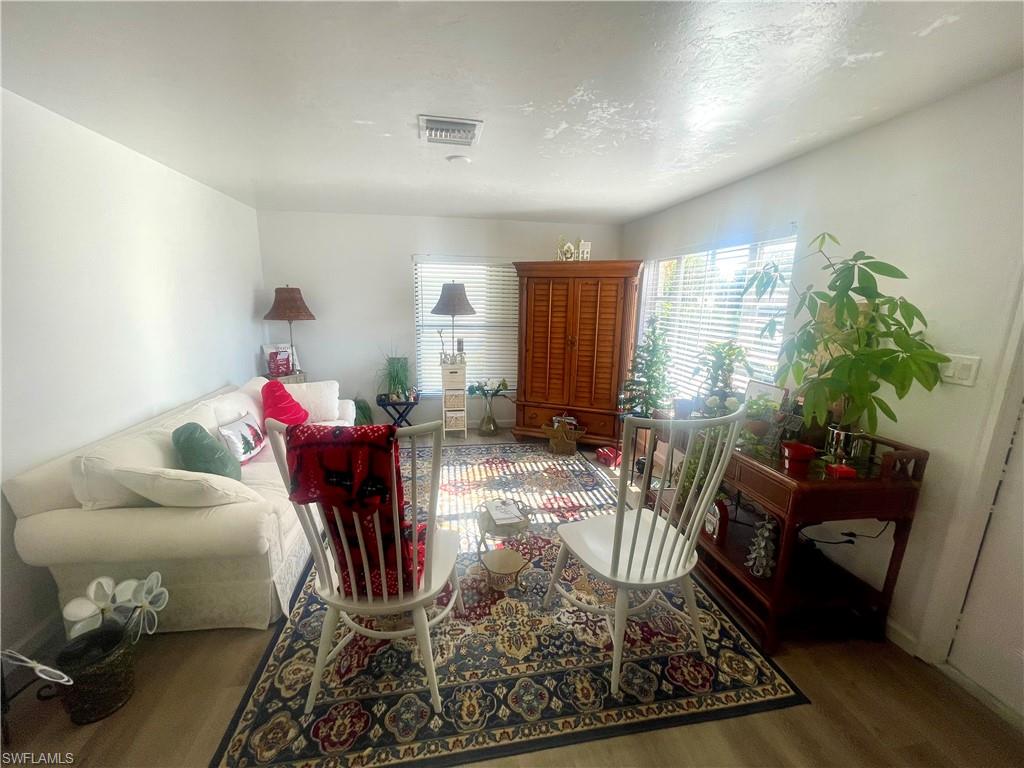 1339 5th Avenue North Naples, FL 34102 - Photo 3 of 17 Living area with wood finished floors and a textured ceiling