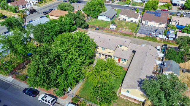 an aerial view of a house with a yard and garden