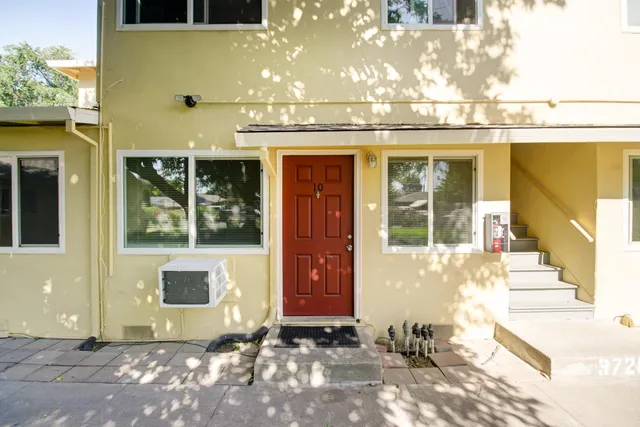 a couple of cars parked in front of a house