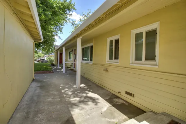 a living room with furniture window and a flat screen tv
