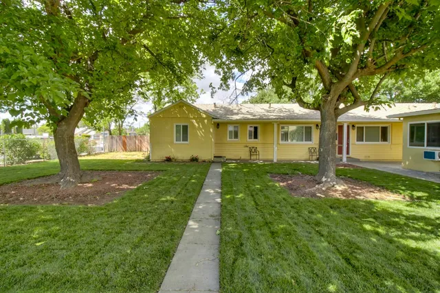 a front view of a house with yard