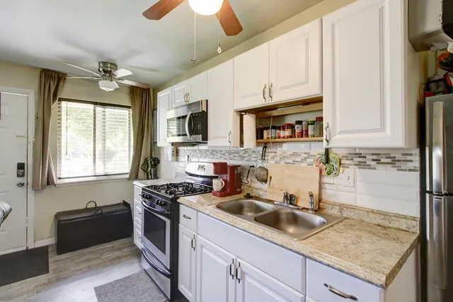a bedroom with a bed and a potted plant