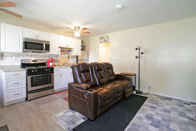 a view of a livingroom with furniture and floor to ceiling window