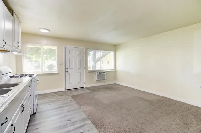 a kitchen with stainless steel appliances granite countertop a stove a sink and a refrigerator