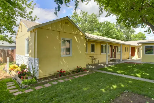 a front view of a house with a garden
