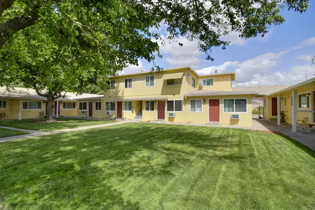 a view of a house with a backyard