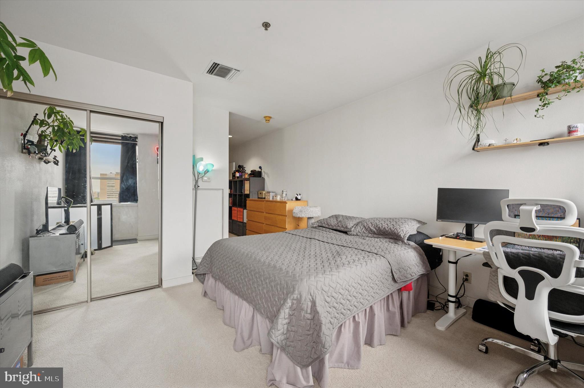 1100-00 Vine Street, Unit 1409 Philadelphia, PA 19107 - Photo 13 of 19 a bedroom with a bed and a couch