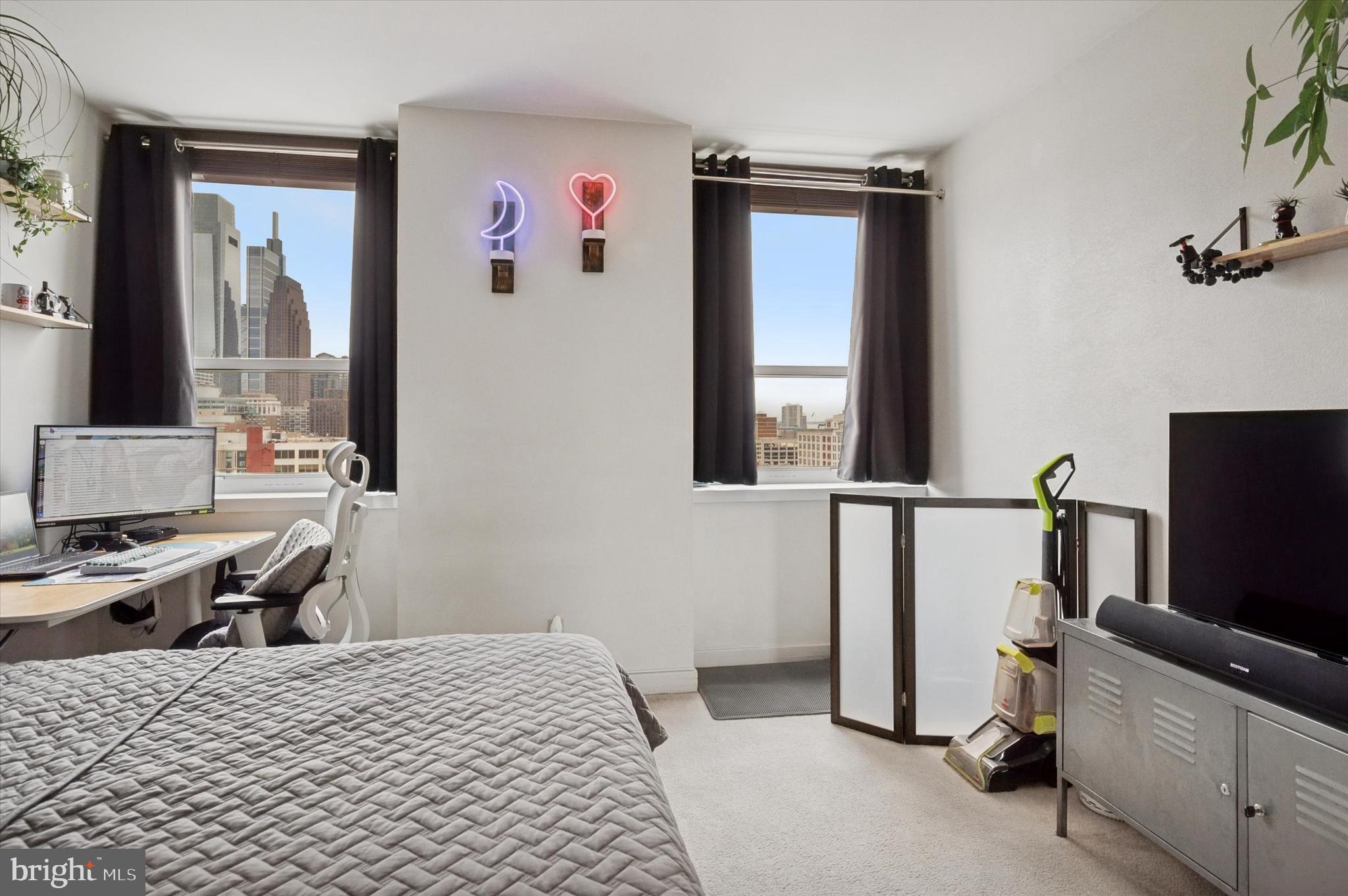 1100-00 Vine Street, Unit 1409 Philadelphia, PA 19107 - Photo 15 of 19 a bedroom with a bed and a flat screen tv