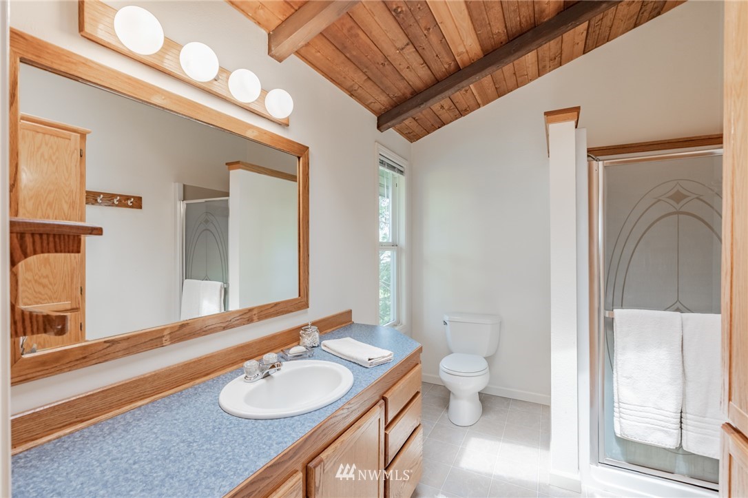 1792 Burk Road Blaine, WA 98230 - Photo 22 of 40 a bathroom with a granite countertop sink toilet and shower
