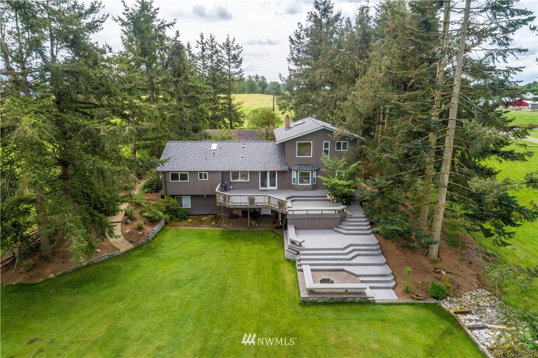 1792 Burk Road Blaine, WA 98230 - Photo 4 of 40 a front view of a house with a yard table and chairs