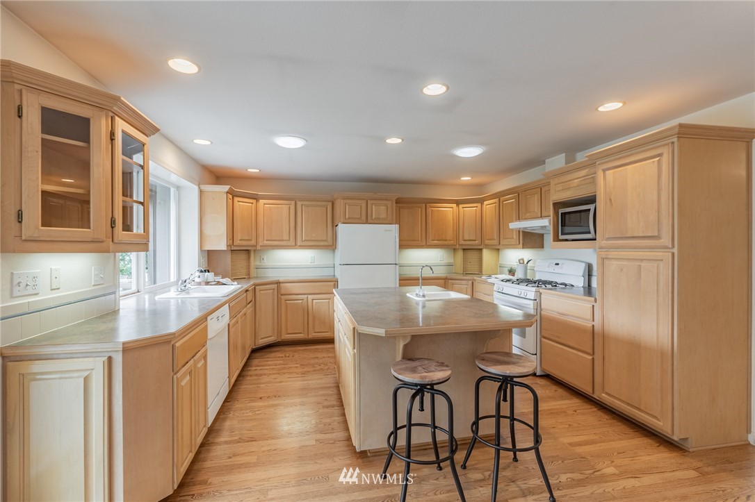 1792 Burk Road Blaine, WA 98230 - Photo 8 of 40 a kitchen with counter top space cabinets and stainless steel appliances