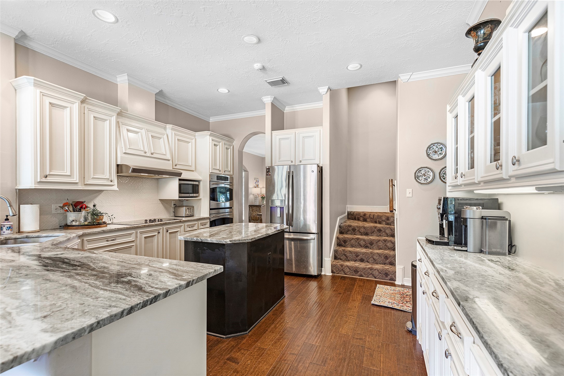 6530 Treaschwig Road, Unit 1 Spring, TX 77373 - Photo 11 of 32 a kitchen with stainless steel appliances granite countertop a kitchen island wooden cabinets and a sink