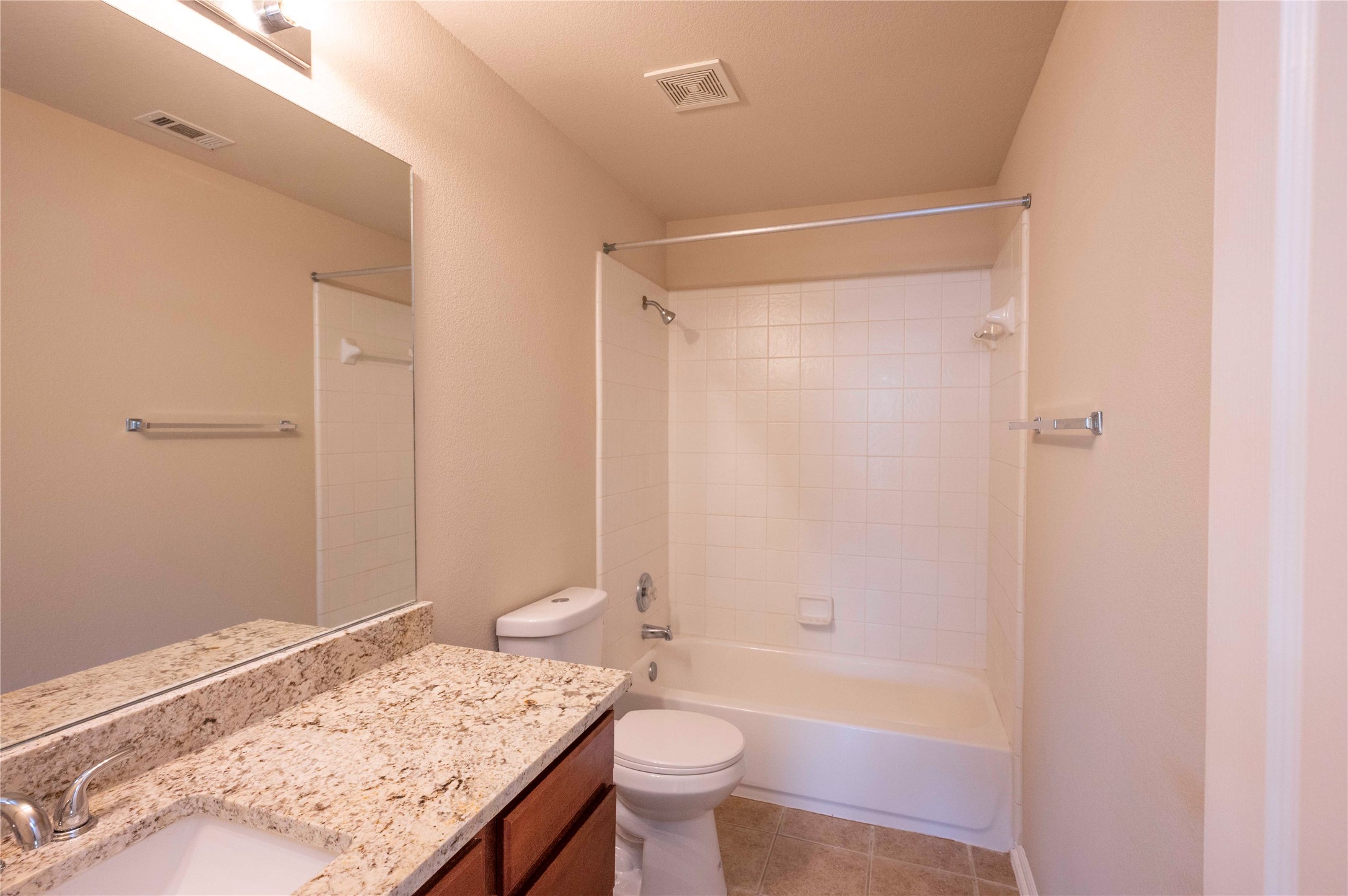 2070 Intrepid Drive Buda, TX 78610 - Photo 23 of 31 Granite counters and tiled flooring outfit this functional and clean bathroom.