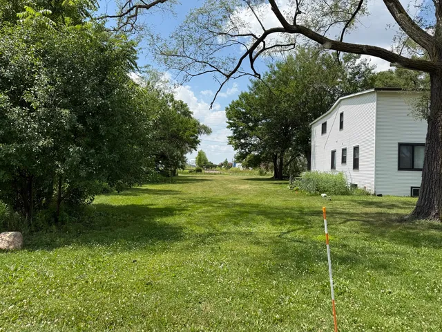 a backyard of a house with table and chairs