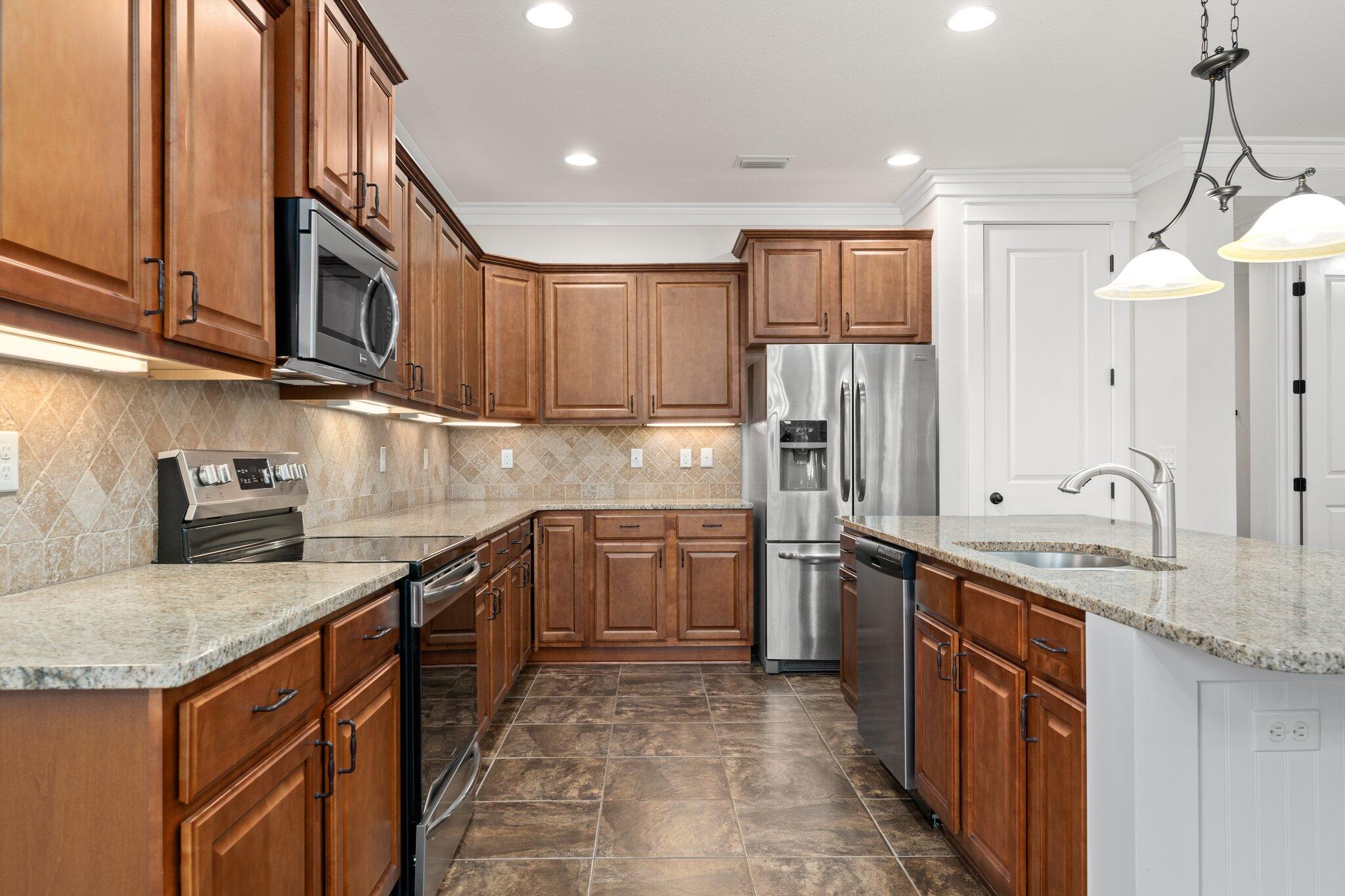 112 Blue Sage Road Panama City Beach, FL 32413 - Photo 14 of 46 a kitchen with stainless steel appliances granite countertop a sink stove and refrigerator