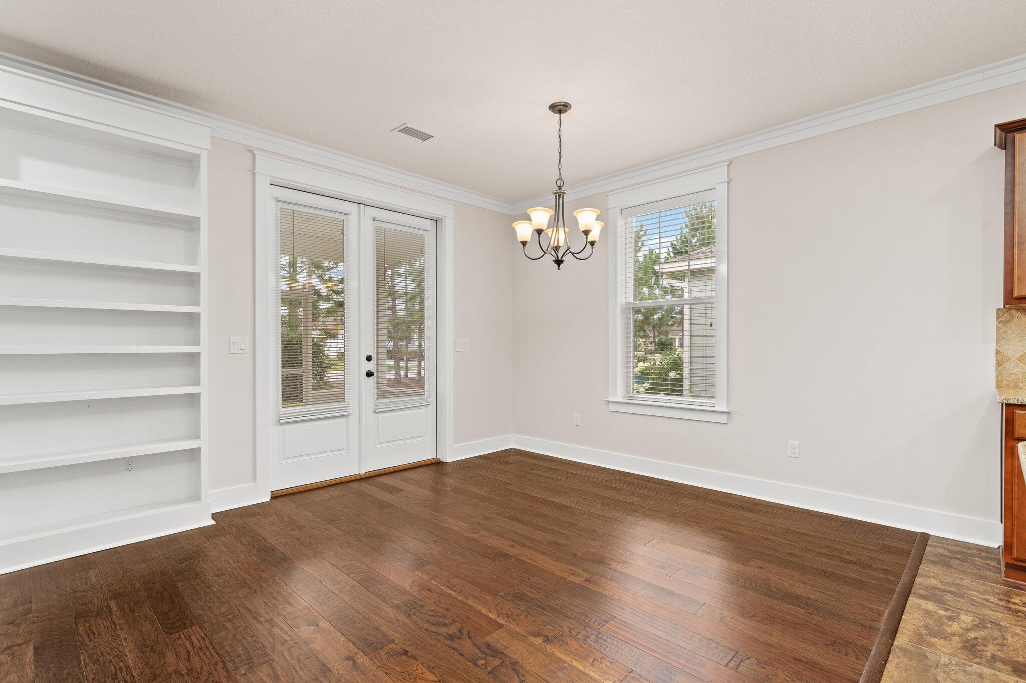 112 Blue Sage Road Panama City Beach, FL 32413 - Photo 18 of 46 a view of an empty room with a window and wooden floor