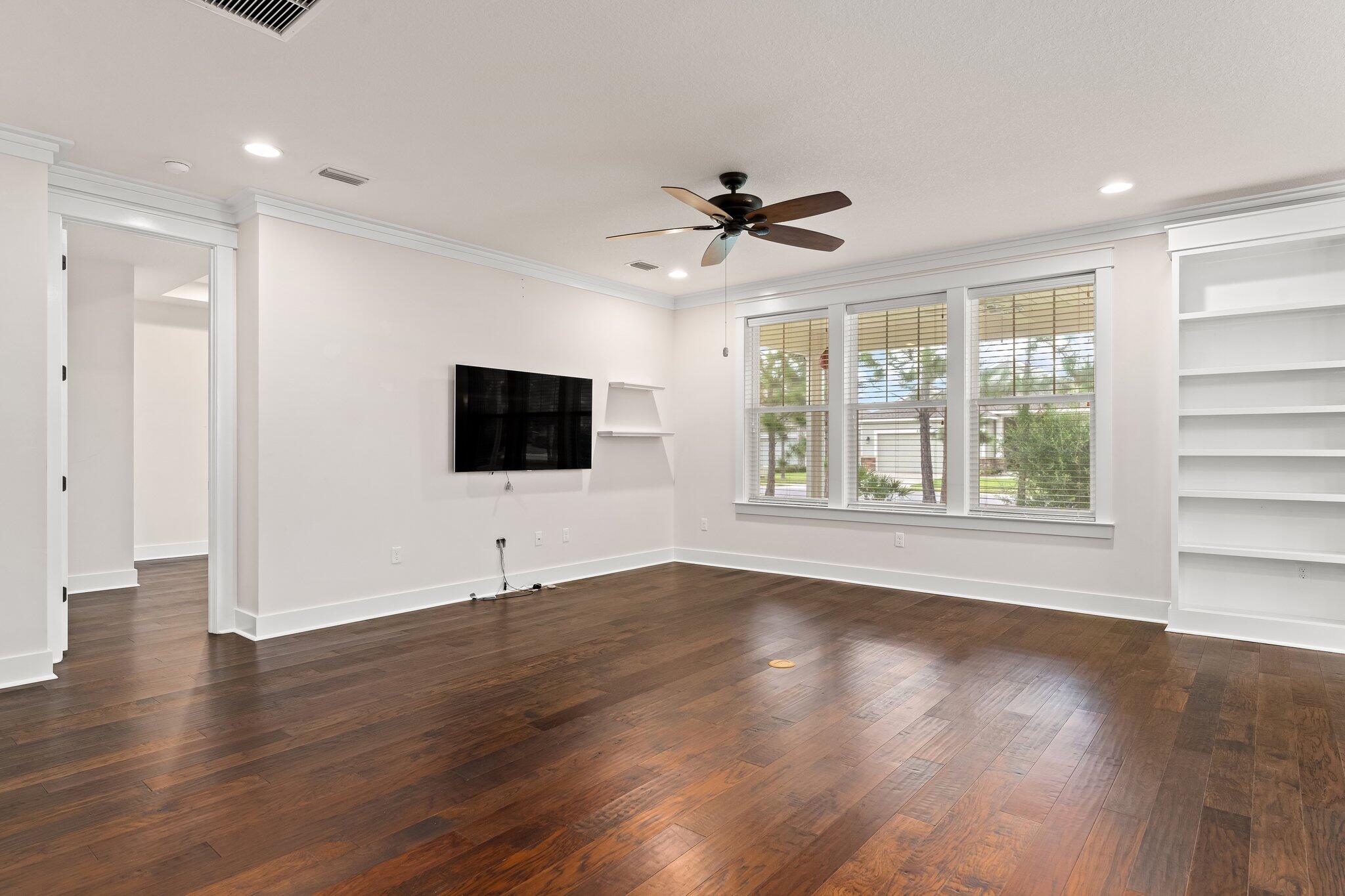 112 Blue Sage Road Panama City Beach, FL 32413 - Photo 19 of 46 a view of an empty room with wooden floor and a window