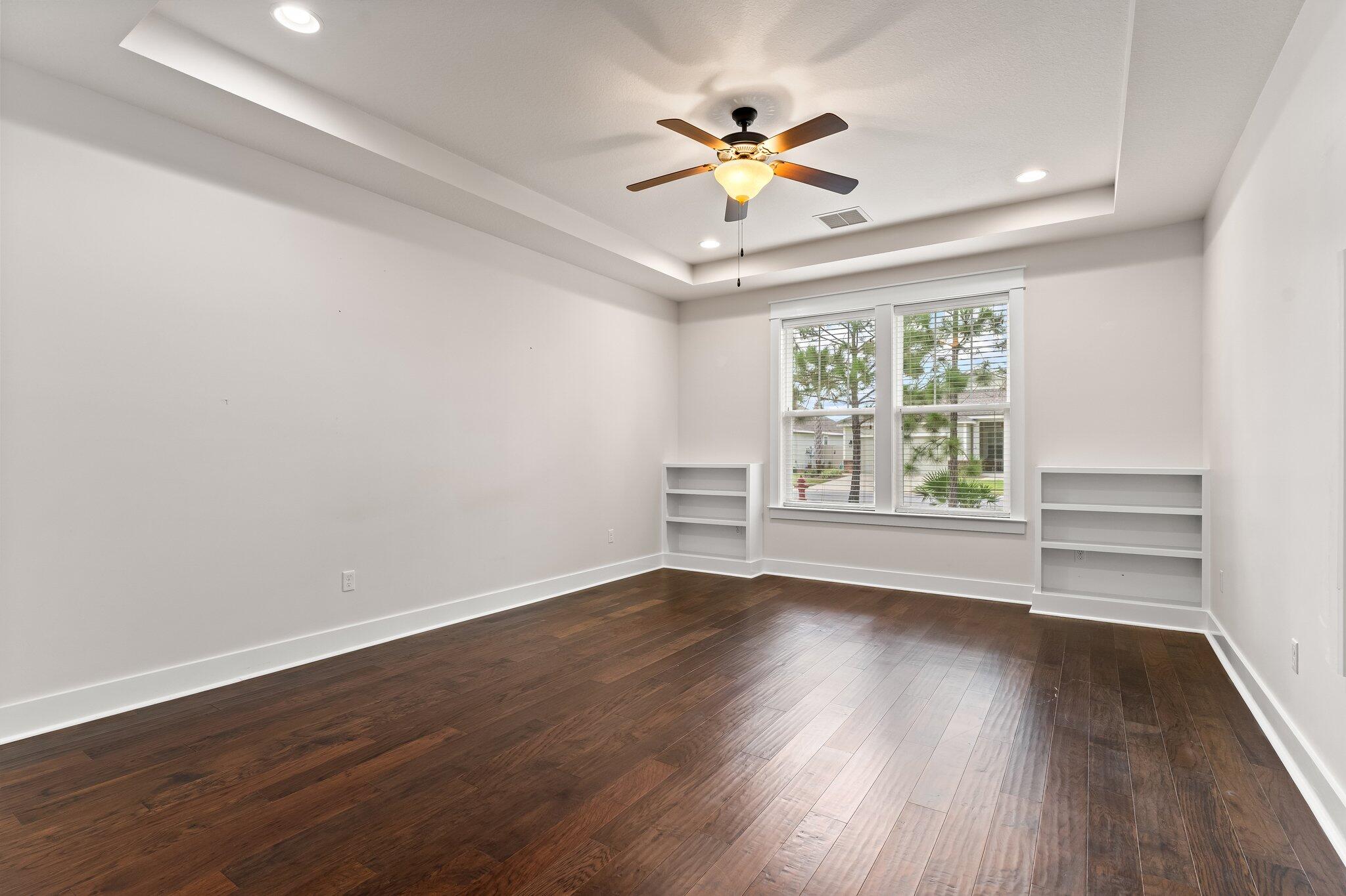 112 Blue Sage Road Panama City Beach, FL 32413 - Photo 22 of 46 a view of an empty room with a window and wooden floor