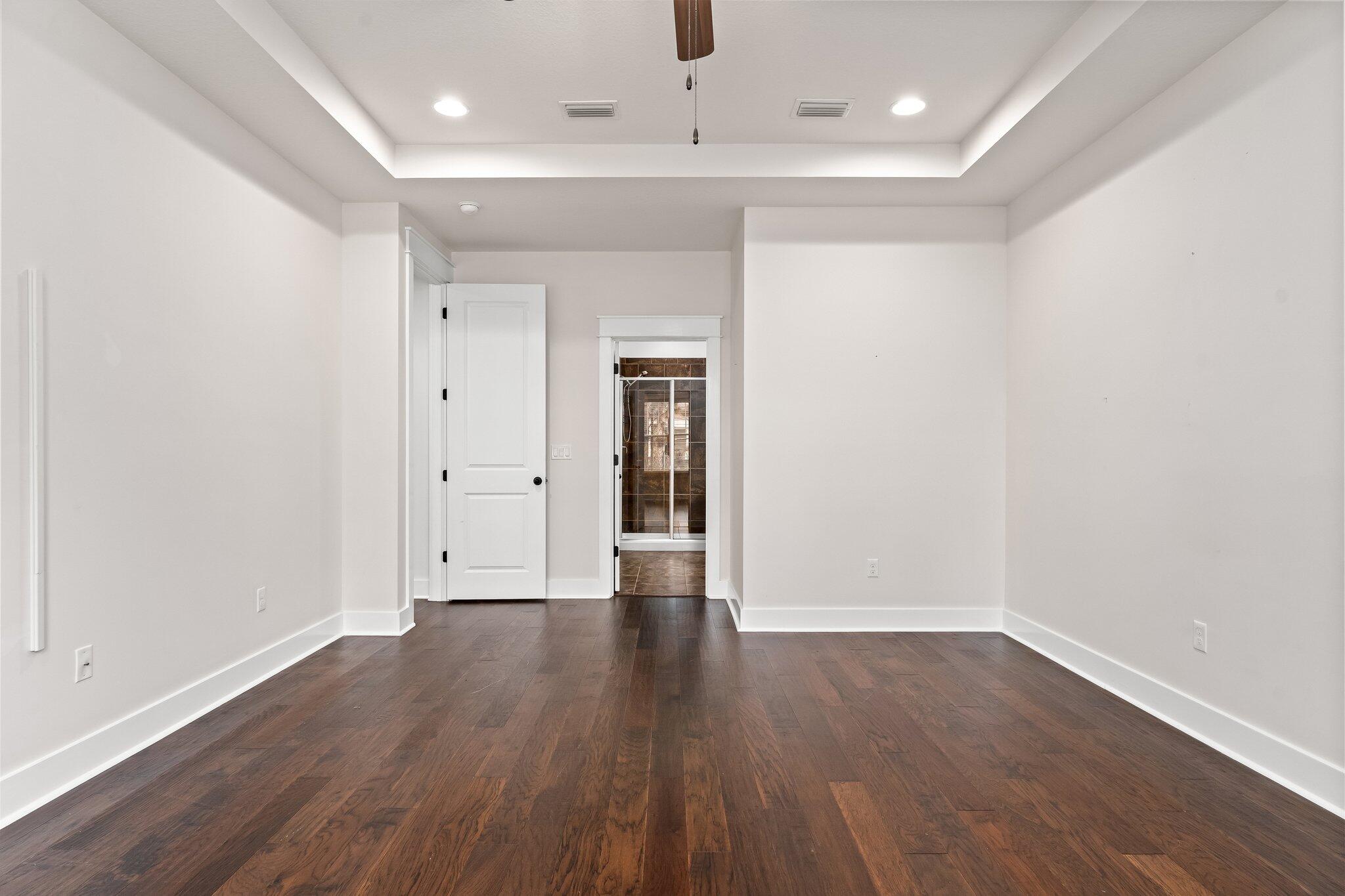 112 Blue Sage Road Panama City Beach, FL 32413 - Photo 24 of 46 a view of an empty room with wooden floor