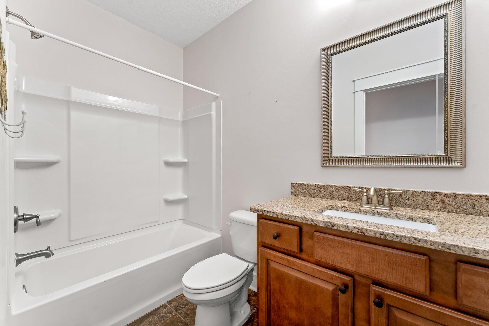 112 Blue Sage Road Panama City Beach, FL 32413 - Photo 29 of 46 a bathroom with a granite countertop toilet sink and mirror
