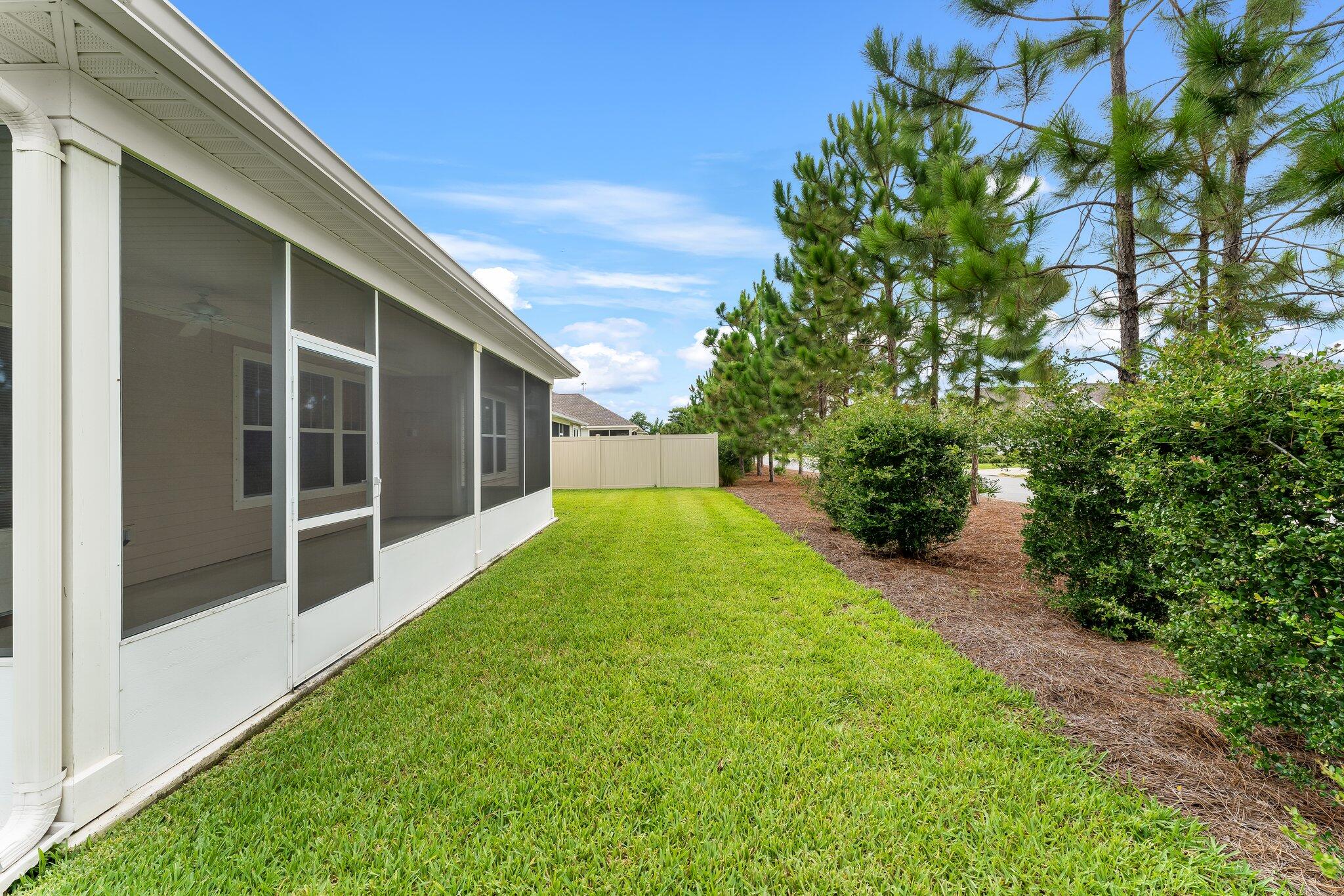 112 Blue Sage Road Panama City Beach, FL 32413 - Photo 36 of 46 a view of an house with backyard space and garden