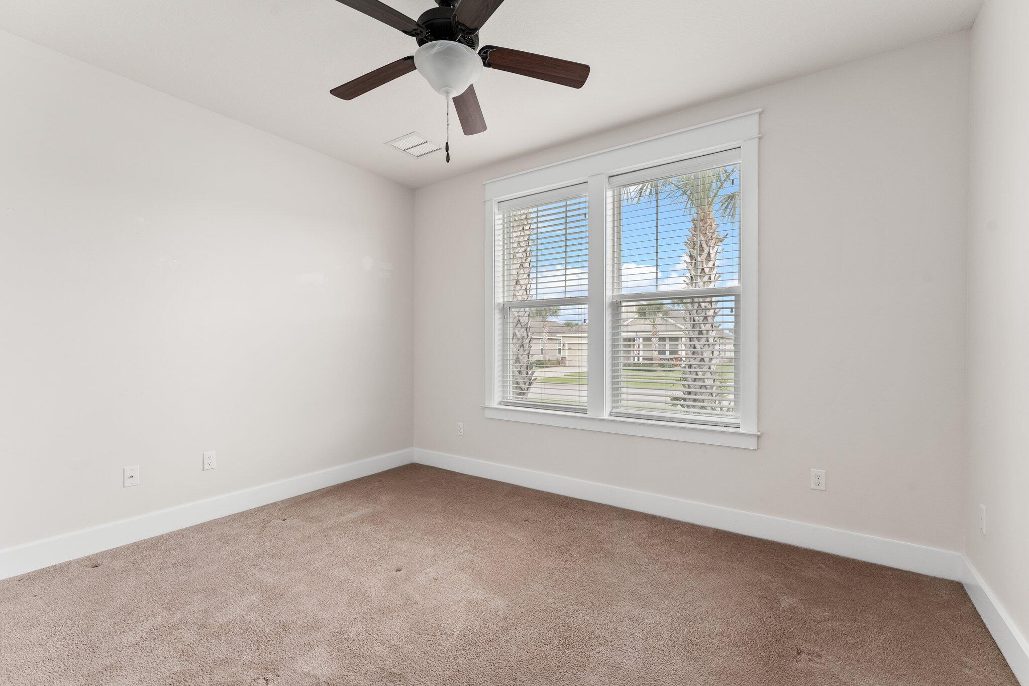 112 Blue Sage Road Panama City Beach, FL 32413 - Photo 6 of 46 an empty room with a window and a fan