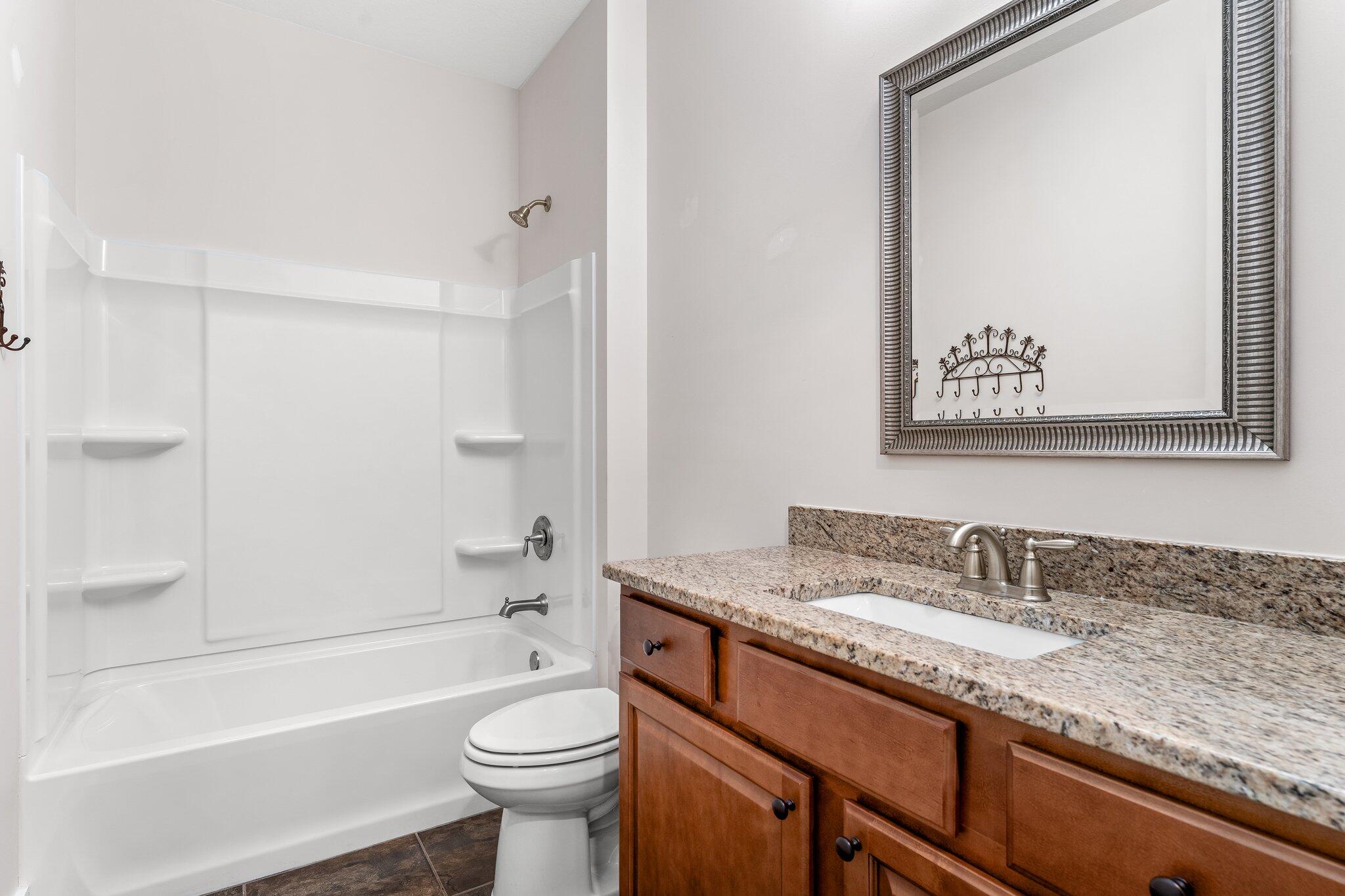 112 Blue Sage Road Panama City Beach, FL 32413 - Photo 8 of 46 a bathroom with a granite countertop toilet sink and bathtub