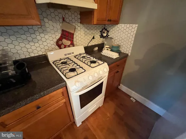 a stove top oven sitting inside of a kitchen