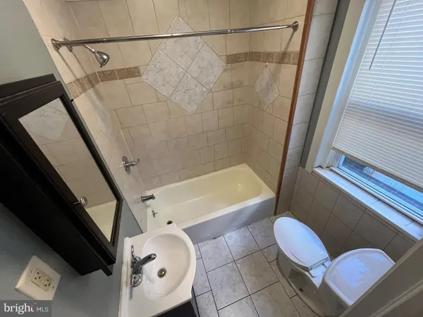 a bathroom with a toilet tub and sink