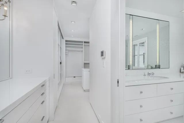 a bathroom with a sink a mirror and a shower