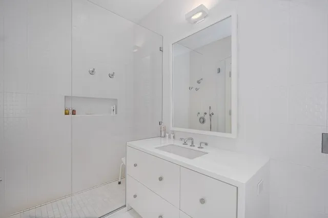a bathroom with a sink a vanity and a mirror