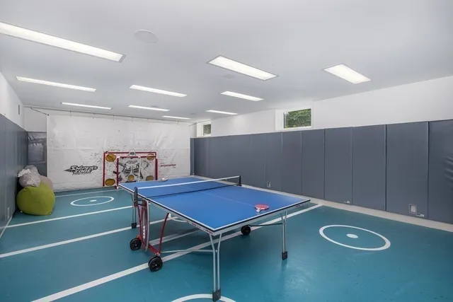a room with furniture and air hockey table
