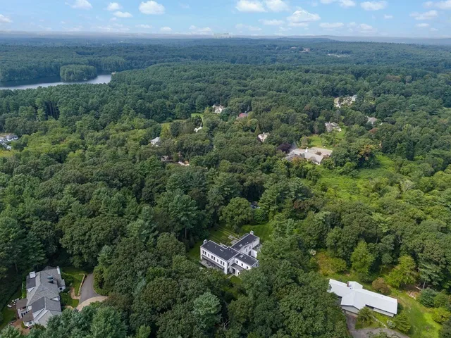 an aerial view of a city with lots of residential buildings and mountain view in back