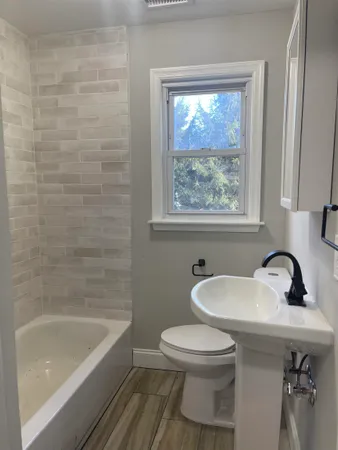 a bathroom with a sink a toilet and bathtub