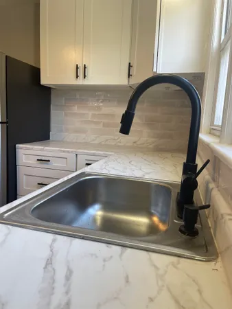 a kitchen with a sink and a refrigerator