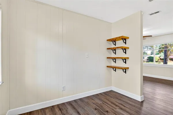 an empty room with wooden floor and closet