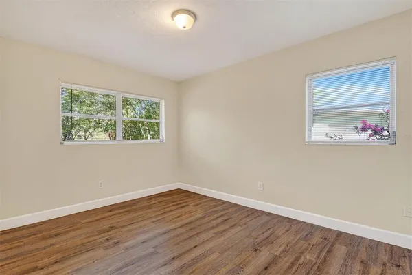 a view of a room with wooden floor and window