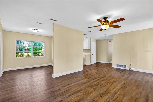 wooden floor in an empty room with a window