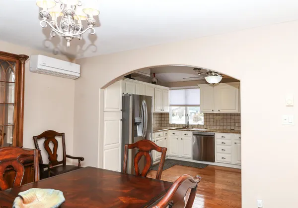 a kitchen with granite countertop a stove a sink and a refrigerator