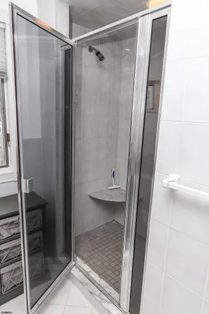 a bathroom with a glass door shower