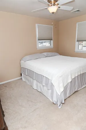 a spacious bedroom with a bed and a table