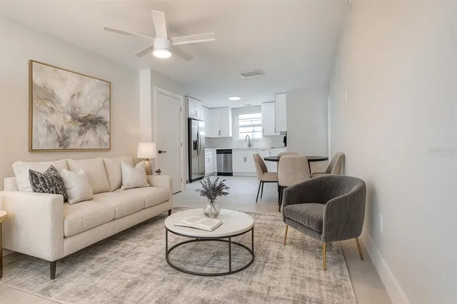 a bedroom with bed and a painting on the wall