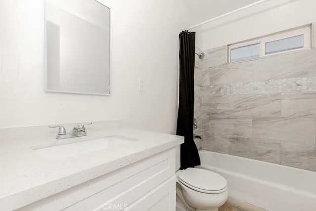 a bathroom with a sink a toilet and a bathtub