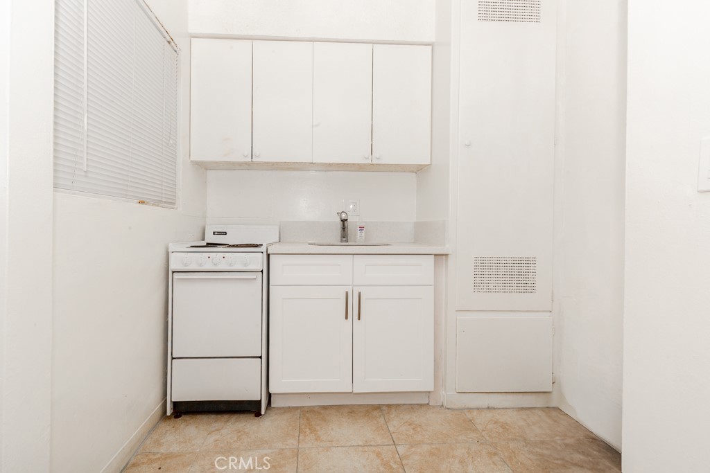 518 West Fredricks Street Barstow, CA 92311 - Photo 16 of 35 a kitchen with white cabinets and sink